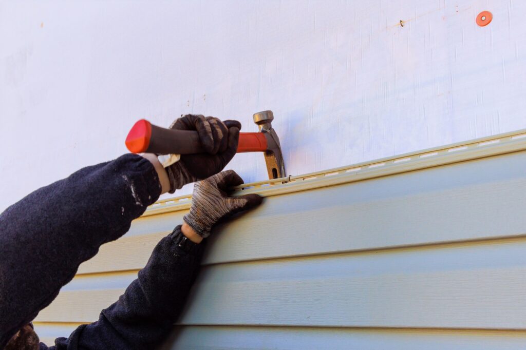 Siding 5 Damaged plastic siding of house is replaced during a reconstruction of its exterior